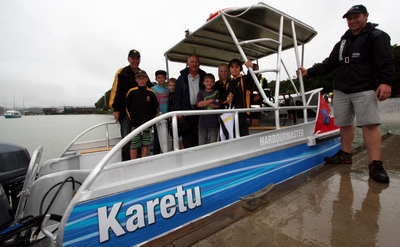 Karetu School principal Ken Timperley, left, some of his pupils and Karetu kaumatua Harry Mahanga on board the newly-named Northland Regional Council workboat 'Karetu' today.  On the jetty is Opua-based regional council maritime officer Blake Cameron.